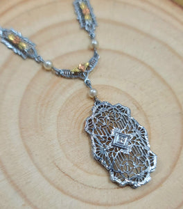 Art Deco pearl pendant necklace with ornate filigree teardrop pendant and chain