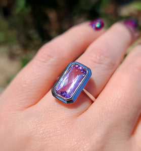 14k white gold surrounds an emerald cut amethyst in this stunning design