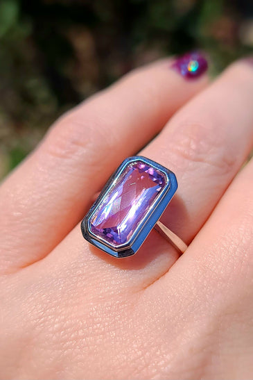 14k white gold surrounds an emerald cut amethyst in this stunning design