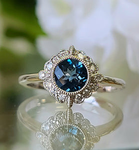 14k white gold ring featuring a round london blue topaz