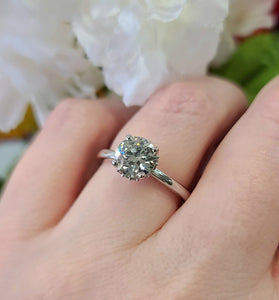 elegant 14k white gold ring with a 159cttw lab grown diamond surrounded by a halo design