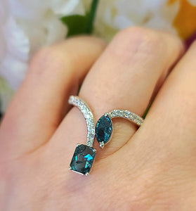 high-end 14k white gold ring with 2 blue diamonds and several white diamonds