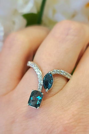 high-end 14k white gold ring with 2 blue diamonds and several white diamonds
