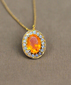 10kt yellow gold halo pendant with orange oval fire opal and round sparkle stones