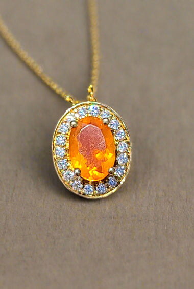 10kt yellow gold halo pendant with orange oval fire opal and round sparkle stones