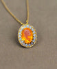 10kt yellow gold halo pendant with orange oval fire opal and round sparkle stones
