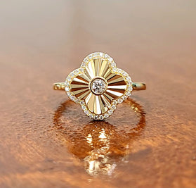 Gold clover ring with round center diamond and diamond halo