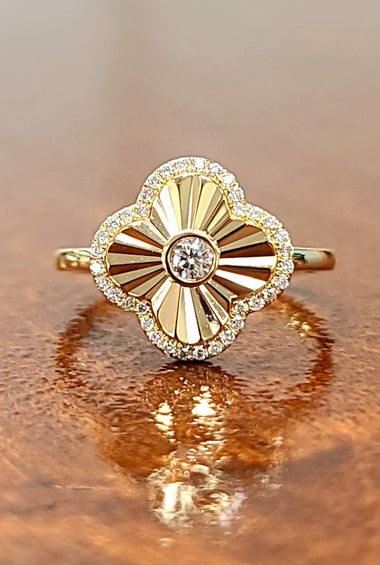 Gold clover ring with round center diamond and diamond halo