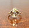 Gold clover ring with round center diamond and diamond halo