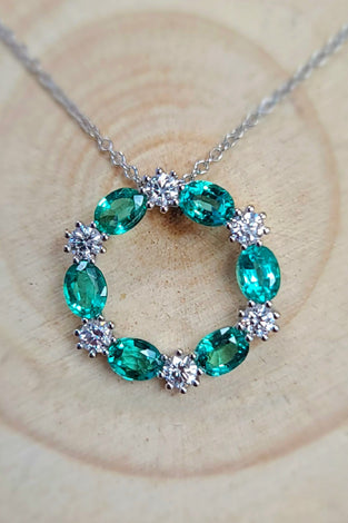 14k yellow gold creates a stunning pendent with emerald and diamond