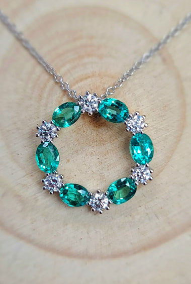 14kt yellow gold circular emerald-and-diamond pendant with green oval stones