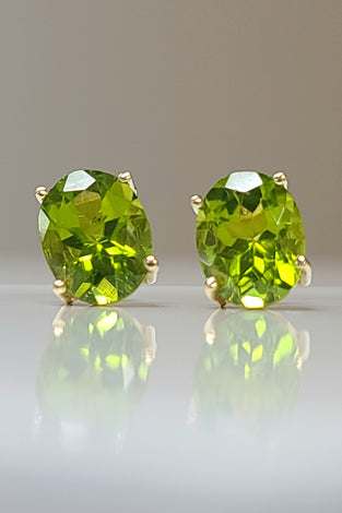 14k yellow gold estate stud earrings featuring oval peridot