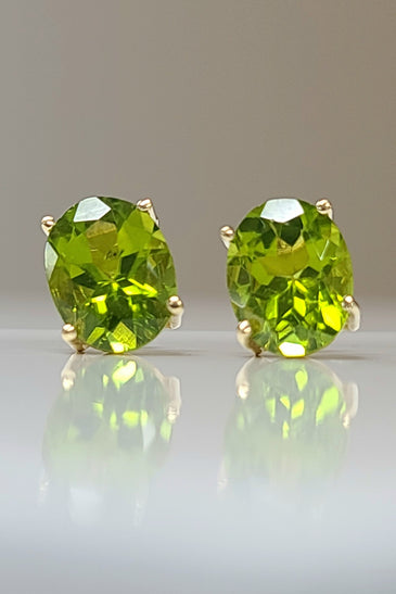 14k yellow gold estate stud earrings featuring oval peridot