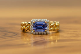 14kt yellow gold ring with blue sapphire and diamond halo, twisted band