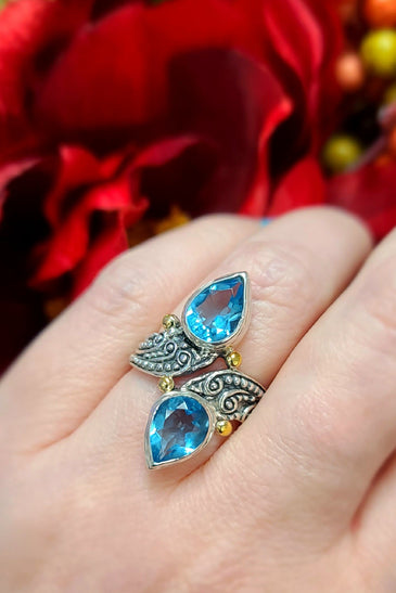 18k yellow gold and sterling silver ring swirled with sparkling blue topaz
