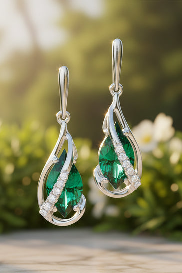 A pair of white gold drop earrings featuring marquise-cut green lab-emerald and melee diamonds 