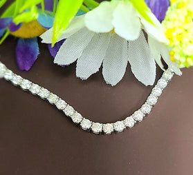 Sterling silver tennis necklace with round moissanite stones, prong-set along chain