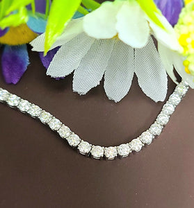 Sterling silver tennis necklace with round moissanite stones, prong-set along chain