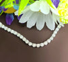 Sterling silver tennis necklace with round moissanite stones, prong-set along chain
