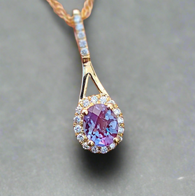 Yellow gold alexandrite diamond pendant with oval stone and diamond halo