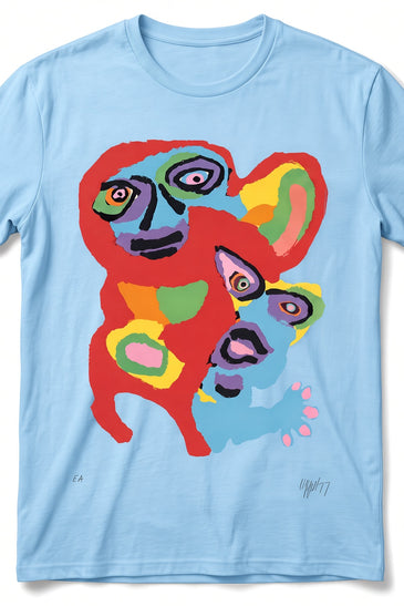 A light blue short-sleeve crewneck t-shirt featuring a colorful, abstract cartoon-style graphic of two faces on the front, displayed against a clean white background.