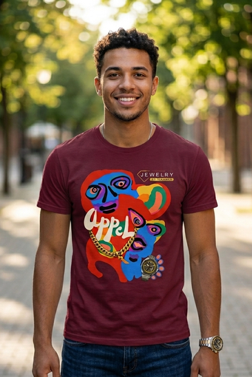 A man wearing a maroon graphic t-shirt with a colorful abstract face design and the text 'JEWELRY by Harold' on the chest,