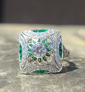 art deco inspired ring featuring sparkling green and white cz stones encased in sterling silver