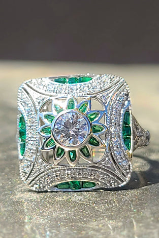 art deco inspired ring featuring sparkling green and white cz stones encased in sterling silver