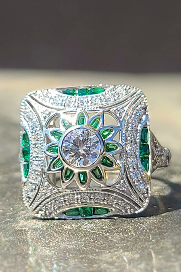 art deco inspired ring featuring sparkling green and white cz stones encased in sterling silver