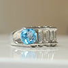 Sterling silver ring with oval blue topaz and baguette diamond accents