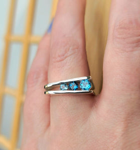 asymmetrical sterling silver ring featuring blue topaz