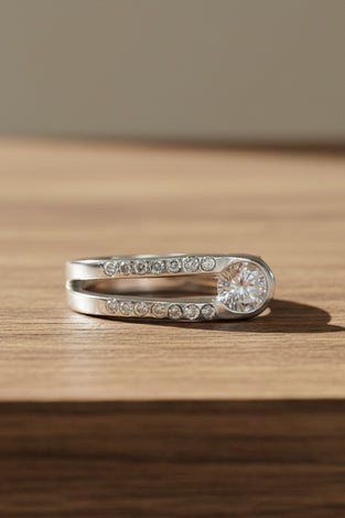 Sterling silver ring with pavé stones and round white topaz center