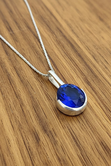 Sterling Silver Lab Blue Sapphire Half Bezel Pendant