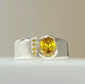 Sterling silver CZ ring with large yellow bezel-set center stone and side accents
