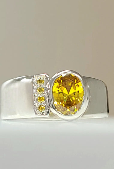 Sterling silver CZ ring with large yellow bezel-set center stone and side accents