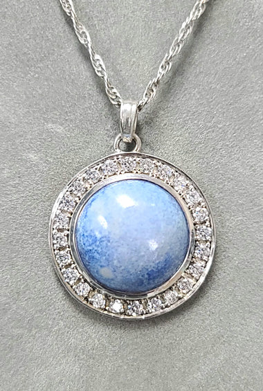 Sterling silver pendant with round blue dyed agate center and crystal halo bezel