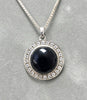 Sterling silver onyx pendant with round black cabochon and crystal halo