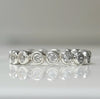 Sterling silver eternity ring with round white topaz stones across the band