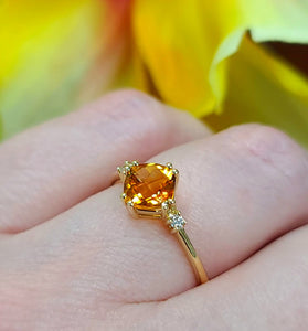 citrine stone surrounded by sparkling diamonds on a 14k yellow gold band