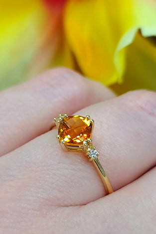 citrine stone surrounded by sparkling diamonds on a 14k yellow gold band
