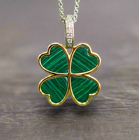 Four-leaf clover pendant with green malachite set, gold-tone frame on silver chain