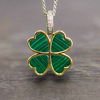 Four-leaf clover pendant with green malachite set, gold-tone frame on silver chain