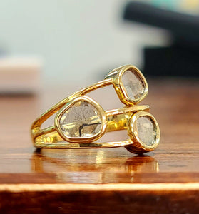 unique free form salt + pepper diamonds encased in a 14k yellow gold bezel
