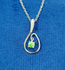 White gold teardrop pendant with peridot and diamond accents on a chain