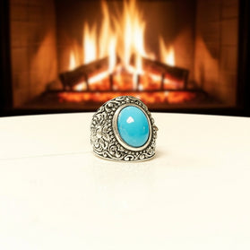 Men's sterling silver ring with filigree border and oval turquoise cabochon