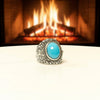 Men's sterling silver ring with filigree border and oval turquoise cabochon