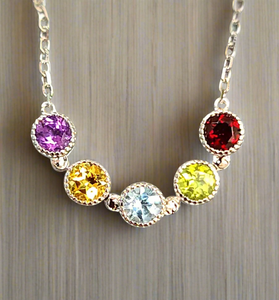 Sterling silver chain necklace with five bezel-set round gems: purple, yellow, blue, lime, red