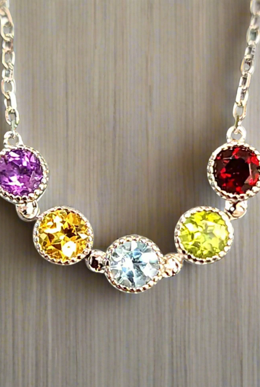Sterling silver chain necklace with five bezel-set round gems: purple, yellow, blue, lime, red