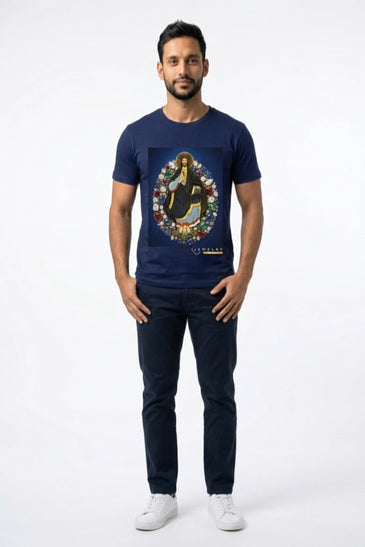 A man modeling a navy blue crewneck t-shirt with a colorful graphic print of Jesus on the chest, paired with dark jeans and white sneakers.