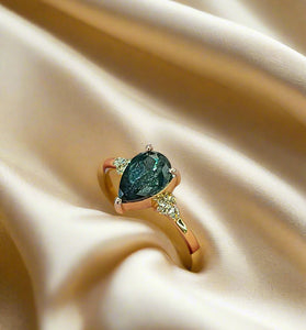 unique pear cut salt and pepper diamond with a 14k yellow gold band
